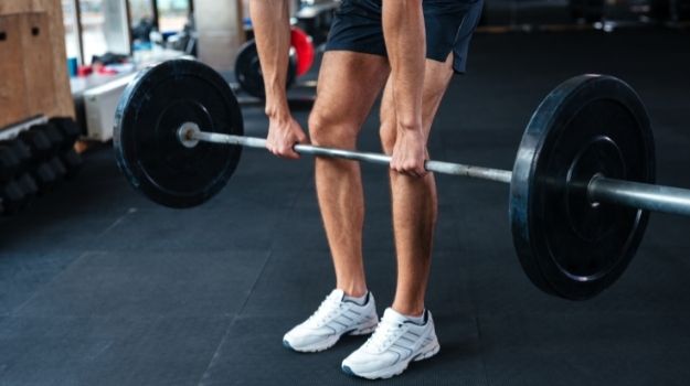 Place your wrists at the hip-width on the barbell